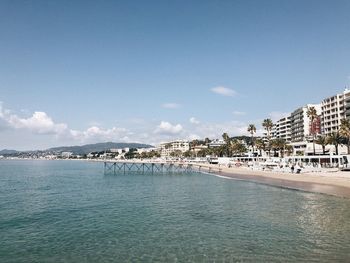 Scenic view of sea and buildings against sky