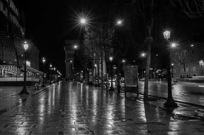 Illuminated street lights in city at night