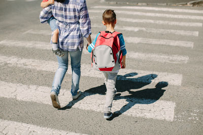 Mother with children on crosswalk