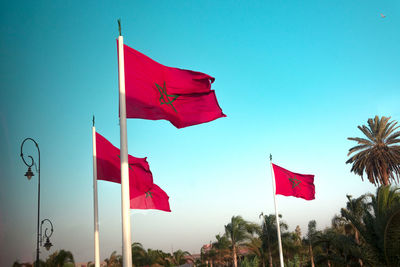 Low angle view of flag flags against sky