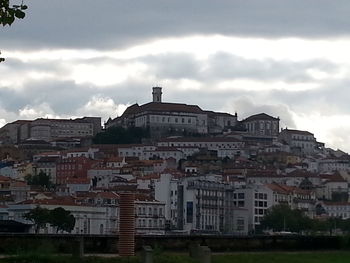 Buildings against cloudy sky