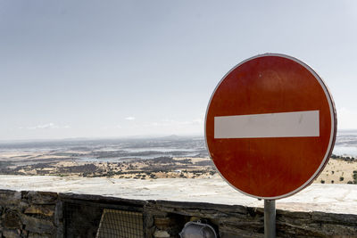 Close-up of road sign against clear sky