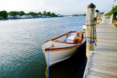 Boat moored in lake against sky