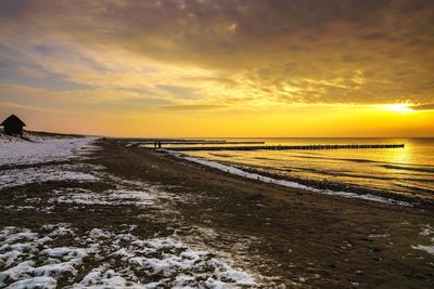 Scenic view of beach against sky during sunset