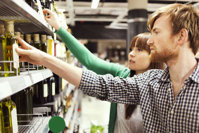 Young couple analyzing products in supermarket