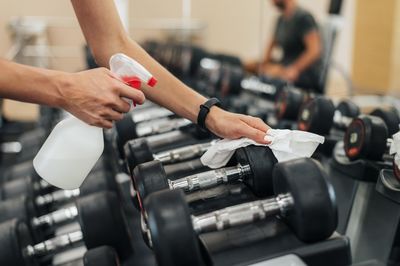 Cropped hands of man exercising in gym