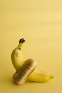 Close-up of banana against yellow background