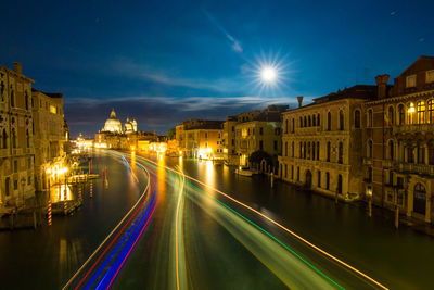 High angle view of light trails on grand canal by santa maria della salute at night