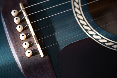 Close-up of guitar strings and bridge