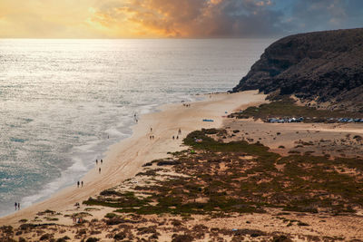 Scenic view of beach against sky during sunset