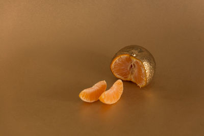 Close-up of fruit against orange background