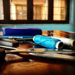 Close-up of sewing equipment on table