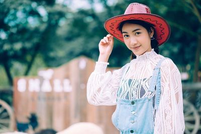 Portrait of smiling young woman standing outdoors