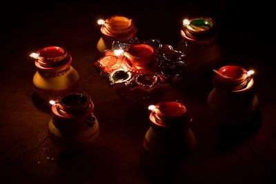 High angle view of lit candles on table