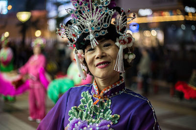 Portrait of smiling woman dancing outdoors