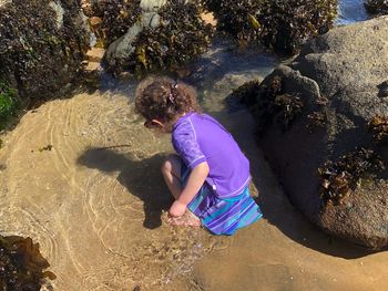 Rear view of girl playing at beach