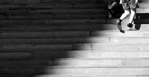 Low section of woman walking on staircase