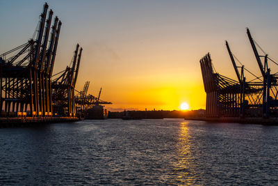 Pier over sea against sky during sunset