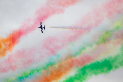 Low angle view of airshow against sky