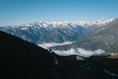 Scenic view of snowcapped mountains against clear sky