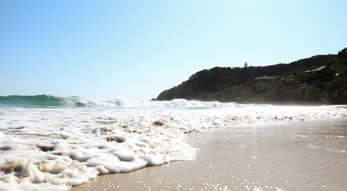 Scenic view of beach against blue sky