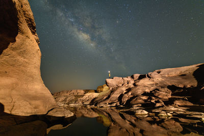 Low angle view of rock formations at night