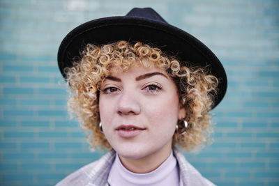 Portrait of teenage girl against wall