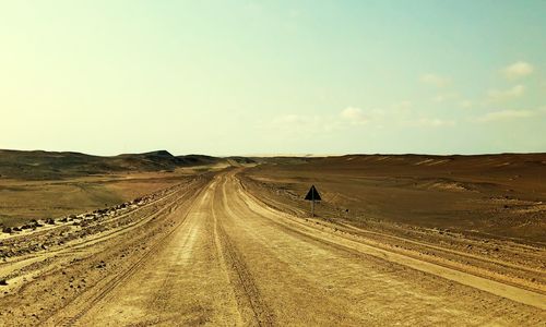 Panoramic view of road passing through desert