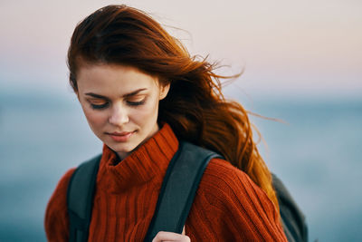 Portrait of beautiful woman against sea