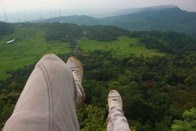 Low section of person wearing shoes on land