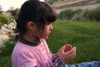Close-up of girl sitting in park