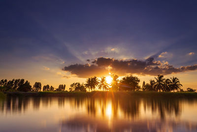 Scenic view of lake against sky during sunset