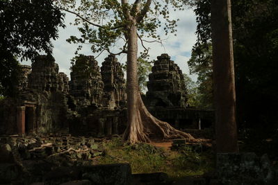 Panoramic view of temple amidst trees and buildings against sky