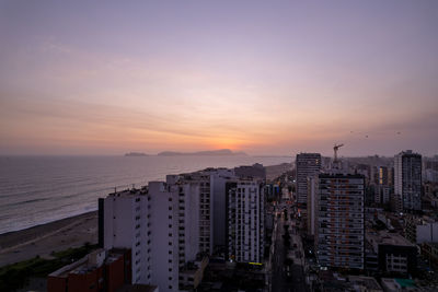 Cityscape against sky during sunset