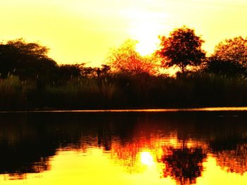 Scenic view of lake at sunset