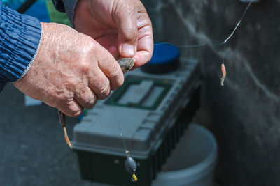 Hands removing the hook from a fish. fisherman fishing perch. 