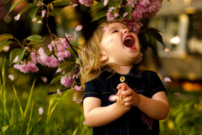 Portrait of girl with flowers on plant