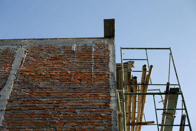 Low angle view of old building against clear blue sky