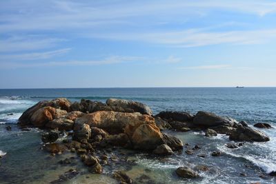 Rocks on beach against sky