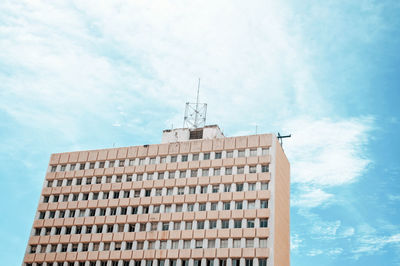 Low angle view of building against cloudy sky