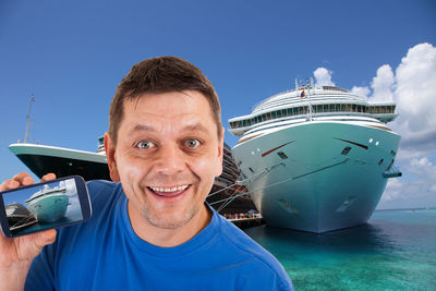 Portrait of smiling man against blue sky