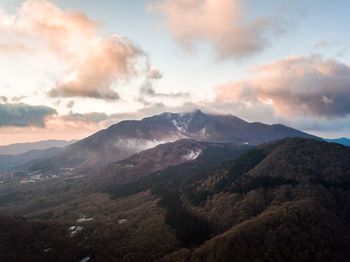 Scenic view of mountains against cloudy sky