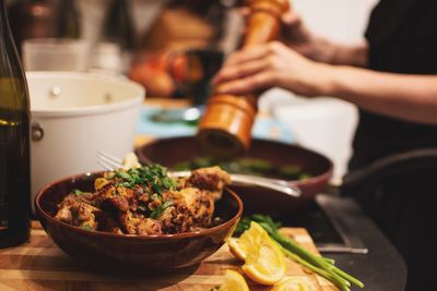 Midsection of chef preparing food on table