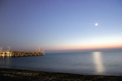 Scenic view of sea against clear sky at night