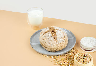 Isometry diagonal projection creative beige background with green buckwheat bread, organic milk