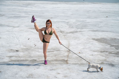 Full length of woman standing on beach