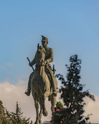 Low angle view of statue against clear blue sky