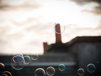 Close-up of bubbles against sky