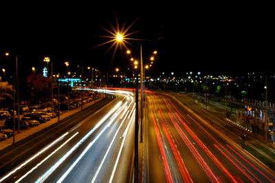 High angle view of light trails on highway at night