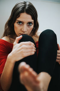 Portrait of young woman sitting at home